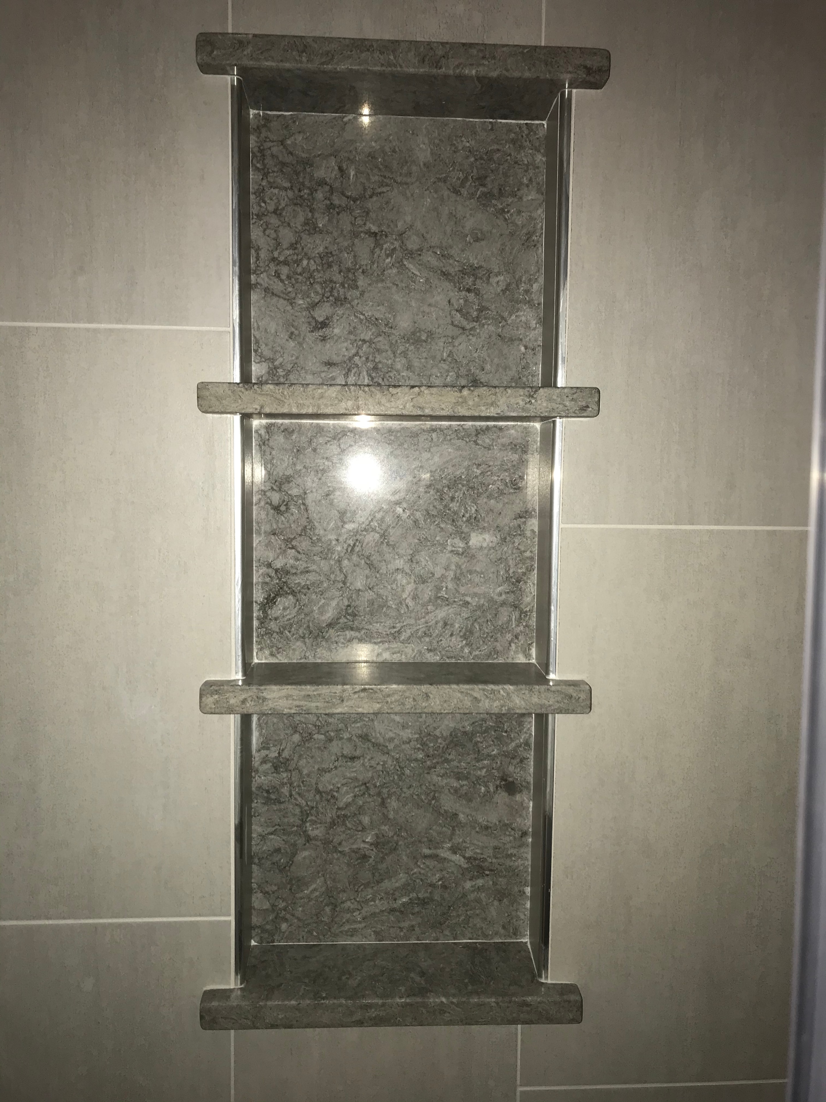 Full bathroom renovation with glass shower and mosaic tile accents