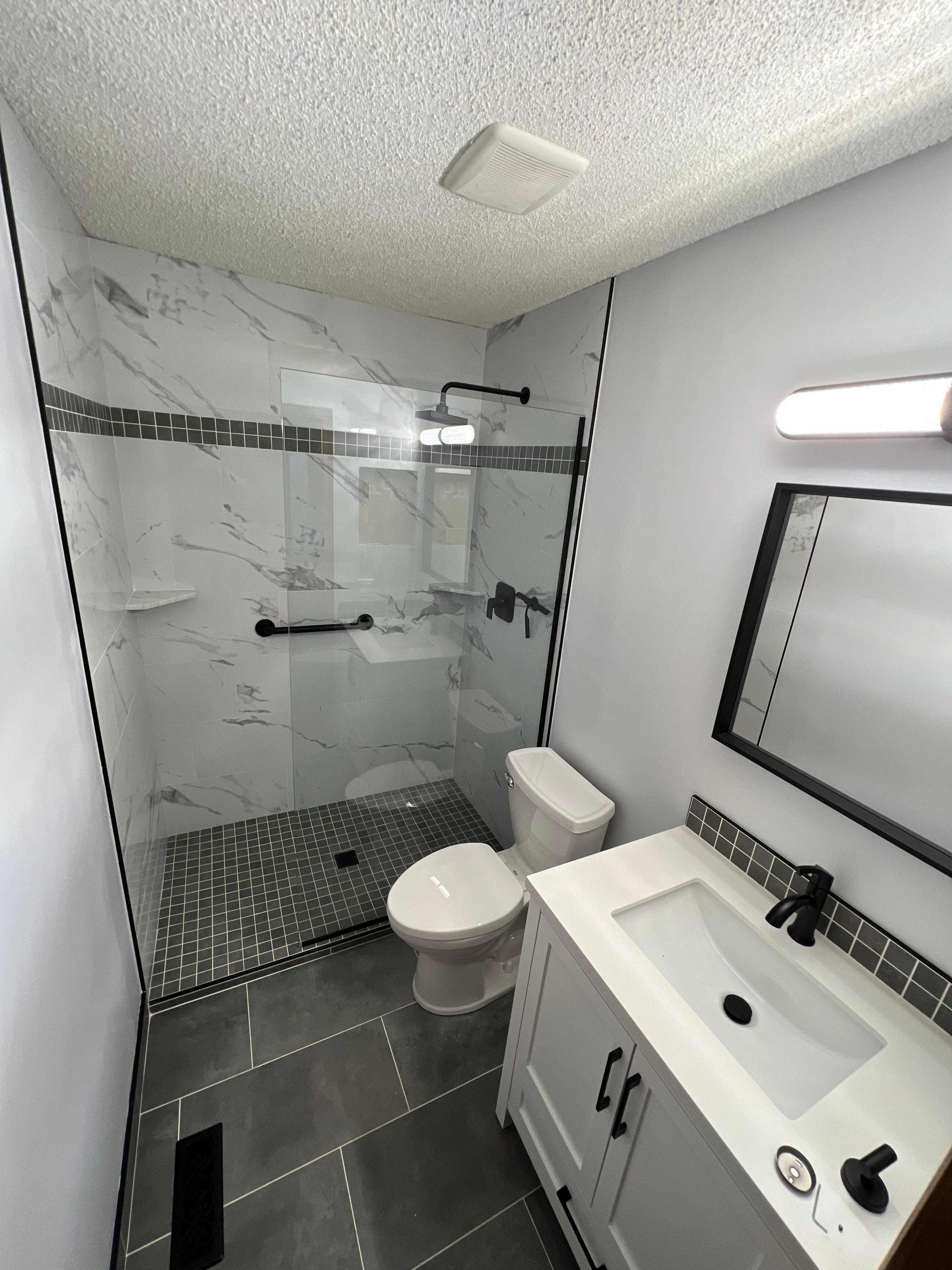 Marble shower niche with three shelves and chrome framing